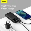 A black power bank is shown charging a smartphone, with a wall adapter plugged into a power strip. Podgląd zdjęcia produktu
