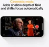 A smartphone displaying a video recording interface with two people in the foreground and background. Produktbild-Vorschau