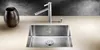 A stainless steel sink with a faucet and a decorative vase on a countertop. Podgląd zdjęcia produktu