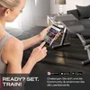 A woman is holding a smartphone in a gym setting, with a weight bench in the background. Produktbild-Vorschau