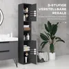 A tall, narrow bathroom cabinet is shown in a modern bathroom setting, next to a sink and a large plant. The cabinet doors are open, revealing adjustable shelves and product placement. Produktbild-Vorschau