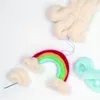 A needle felting kit for making a rainbow with clouds, including wool roving in various colors and a felting needle. Produktbild-Vorschau