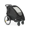 A black child trailer for bicycles, shown from a side-angle on a white background. Produktbild-Vorschau