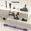 A collection of vacuum cleaner parts and accessories laid out on a multi-level surface. Náhled obrázku produktu