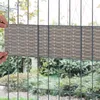Hands attaching a privacy screen to a wire fence in a garden setting. Produktbild-Vorschau
