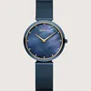 A close-up studio shot of a blue Bering watch with a mother-of-pearl dial and gold accents, set against a plain light gray background. Produktbild-Vorschau