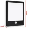 A black outdoor wall lamp with a white illuminated panel and a motion sensor. Produktbild-Vorschau
