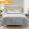 A bed with a light gray blanket is shown in a bedroom setting. Produktbild-Vorschau