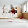 A woman is cleaning a modern kitchen floor with a mop and bucket. Produktbild-Vorschau