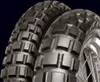 Close-up view of two motorcycle tires with aggressive tread patterns. Produktbild-Vorschau