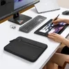 A desk setup with a laptop sleeve, monitor, keyboard, and drawing tablet. Anteprima dell’immagine prodotto