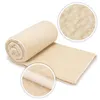 A rolled-up blanket with close-up insets showing the texture. Produktbild-Vorschau