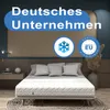 A mattress is displayed on a bed in a bedroom setting, with decorative elements and text overlays. Produktbild-Vorschau