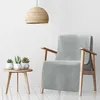 A light grey blanket draped over a wooden armchair, with a small wooden side table holding three potted succulents next to it. A woven pendant light hangs from the ceiling. Náhľad obrázku produktu
