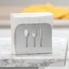 A napkin holder with cutlery cutouts sits on a marble countertop. Produktbild-Vorschau