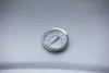 A close-up shot of a thermometer on a metallic surface. Produktbild-Vorschau