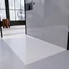 A modern bathroom with a white shower tray and a large window overlooking a city. Produktbild-Vorschau