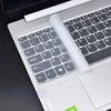 A close-up shot of a transparent laptop keyboard cover being applied to a laptop keyboard. Produktbild-Vorschau