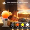 A child sleeping next to an astronaut-shaped alarm clock that simulates a sunrise. Produktbild-Vorschau