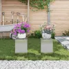 Two plant stands with potted plants in a garden setting. Podgląd zdjęcia produktu