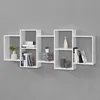 A white modular shelving unit is mounted on a gray wall, displaying various decorative items and books. Náhled obrázku produktu