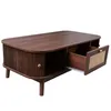 A dark brown coffee table with a drawer pulled out, revealing a rattan insert. Voir les images du produit