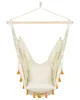 A hanging chair with tassels, suspended from a wooden bar. Produktbild-Vorschau