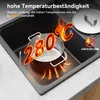 A black granite sink with a pot on it, illustrating high temperature resistance. Produktbild-Vorschau