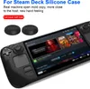 A black silicone case for a Steam Deck gaming console is shown, along with two black thumb grip caps. The console screen displays game art. Produktbild-Vorschau