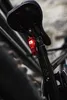 A close-up shot of a bicycle seat post with a red rear light attached. Anteprima dell’immagine prodotto