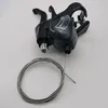 A black bicycle gear shifter with a cable is placed on a white background. Anteprima dell’immagine prodotto