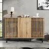 A wooden cabinet with slatted doors and black metal legs, placed against a concrete wall. Anteprima dell’immagine prodotto
