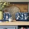 A kitchen counter scene featuring a floral-patterned kettle and toaster, alongside a mug and a small bowl. Produktbild-Vorschau