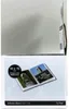 The image shows the packaging of a softcover photo album. The packaging displays an image of an open album with photos inside, along with product specifications. Produktbild-Vorschau