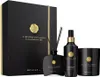 A gift set of Rituals Precious Amber products, including a diffuser, body perfume, and candle, presented in a black gift box. Produktbild-Vorschau