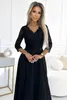 A woman is posing in a black dress. Anteprima dell’immagine prodotto