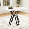 A round dining table with a marble-patterned top and black metal legs, set on a rug in a room with natural light from a window. Produktbild-Vorschau