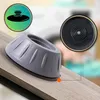 A close-up of a gray anti-vibration pad for appliances, placed on a wooden surface. Inset images show a diagram of the product and a close-up of its base. Podgląd zdjęcia produktu