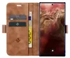 A brown leather wallet-style phone case with a phone inside. Produktbild-Vorschau