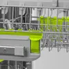 A close-up view of the interior of a dishwasher rack, highlighting the green accents on the racks and drawer. Náhled obrázku produktu