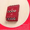 A red jig for drilling angled holes is placed on a light wood surface. Produktbild-Vorschau