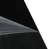 A close-up view of a black surface with a protective film being peeled back. Náhľad obrázku produktu