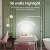 A beauty salon or spa setting with a massage table, chair, and lighting. Produktbild-Vorschau