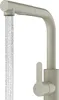 A beige kitchen faucet with water flowing from the spout, isolated on a white background. Podgląd zdjęcia produktu