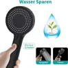 A hand pressing a button on a black shower head, with graphics illustrating water saving and two modes of water flow. Produktbild-Vorschau