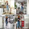 Collage of four images showing a woman using a black and red stepladder in different home settings: kitchen, hallway, garage, and next to stairs. Anteprima dell’immagine prodotto