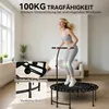 A woman is jumping on a mini trampoline in a living room. Produktbild-Vorschau