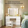 A bedroom scene with a vanity table and stool, alongside a bed. Produktbild-Vorschau