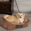 A dog is lying in a dog bed in a room with wooden walls and a wooden cabinet. Podgląd zdjęcia produktu