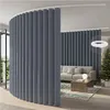 A room divider curtain is set up in a living room with a sofa and a Christmas tree in the background. Produktbild-Vorschau